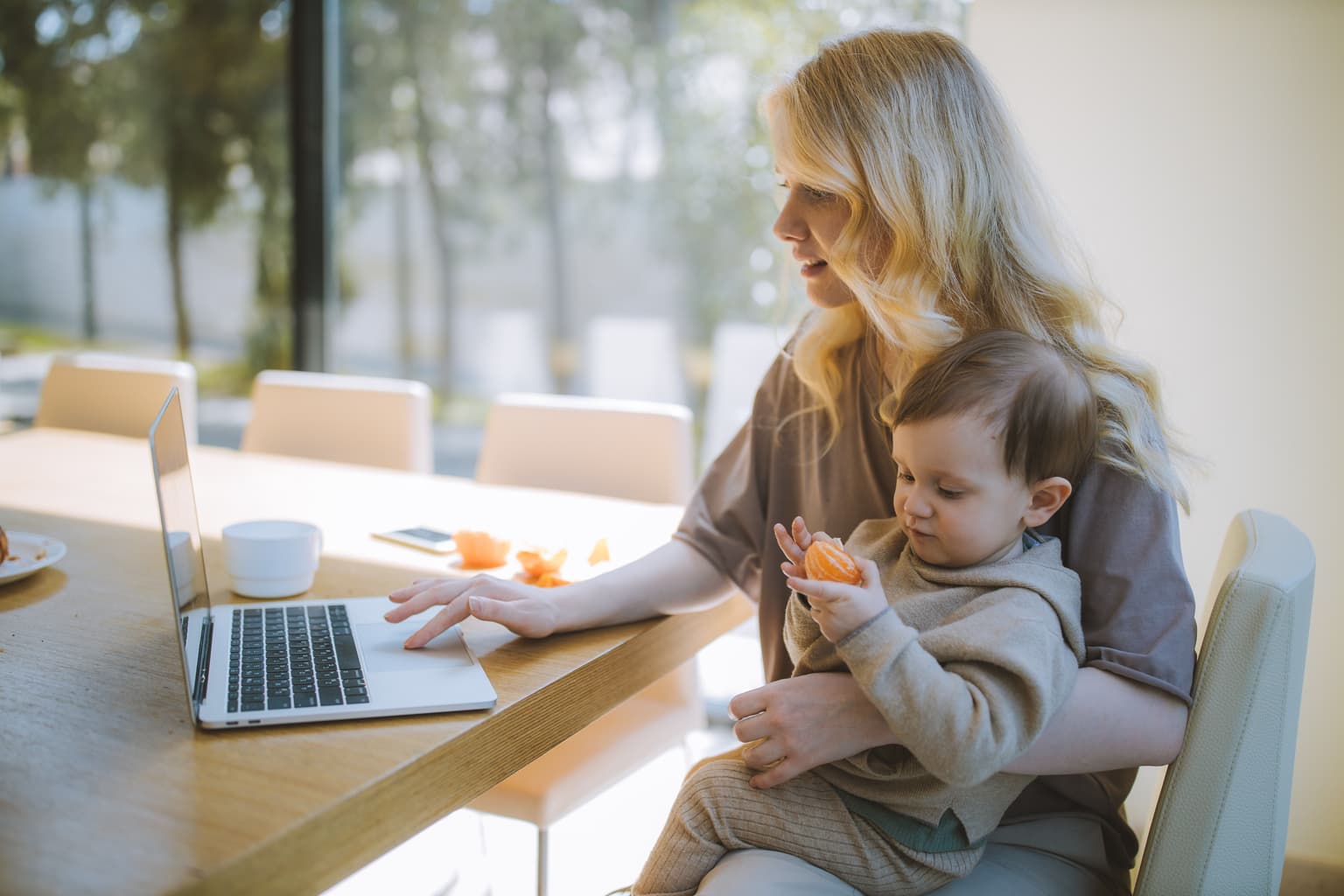 A photo of a woman working remotely on a laptop