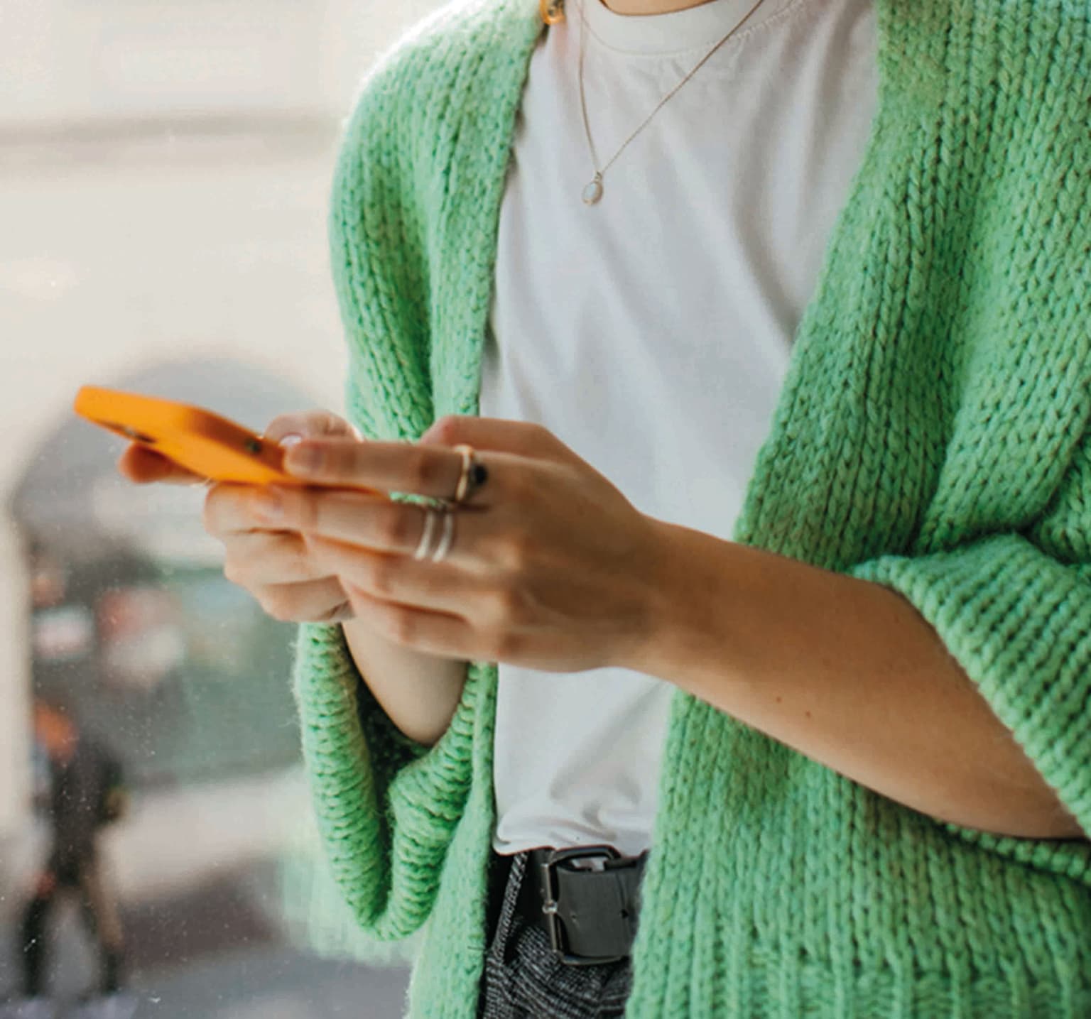 A close up photo of a pair of hands holding a phone